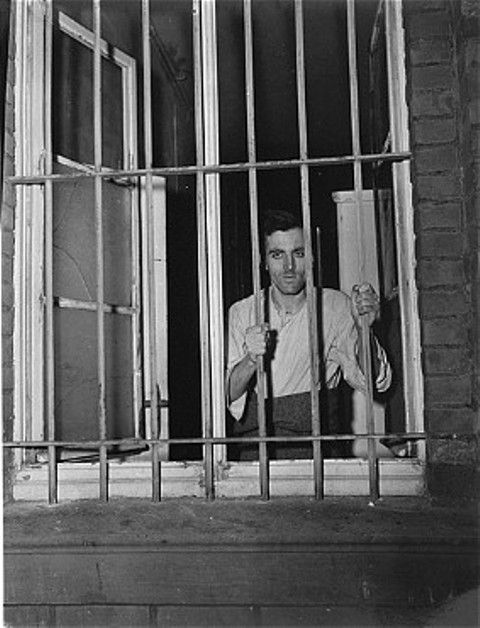 A survivor looks out a barred window at the Hadamar Institute